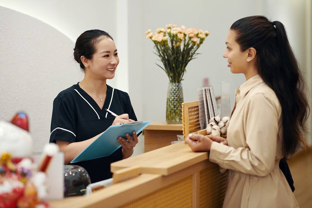 Healthcare receptionist managing upfront collections with patient