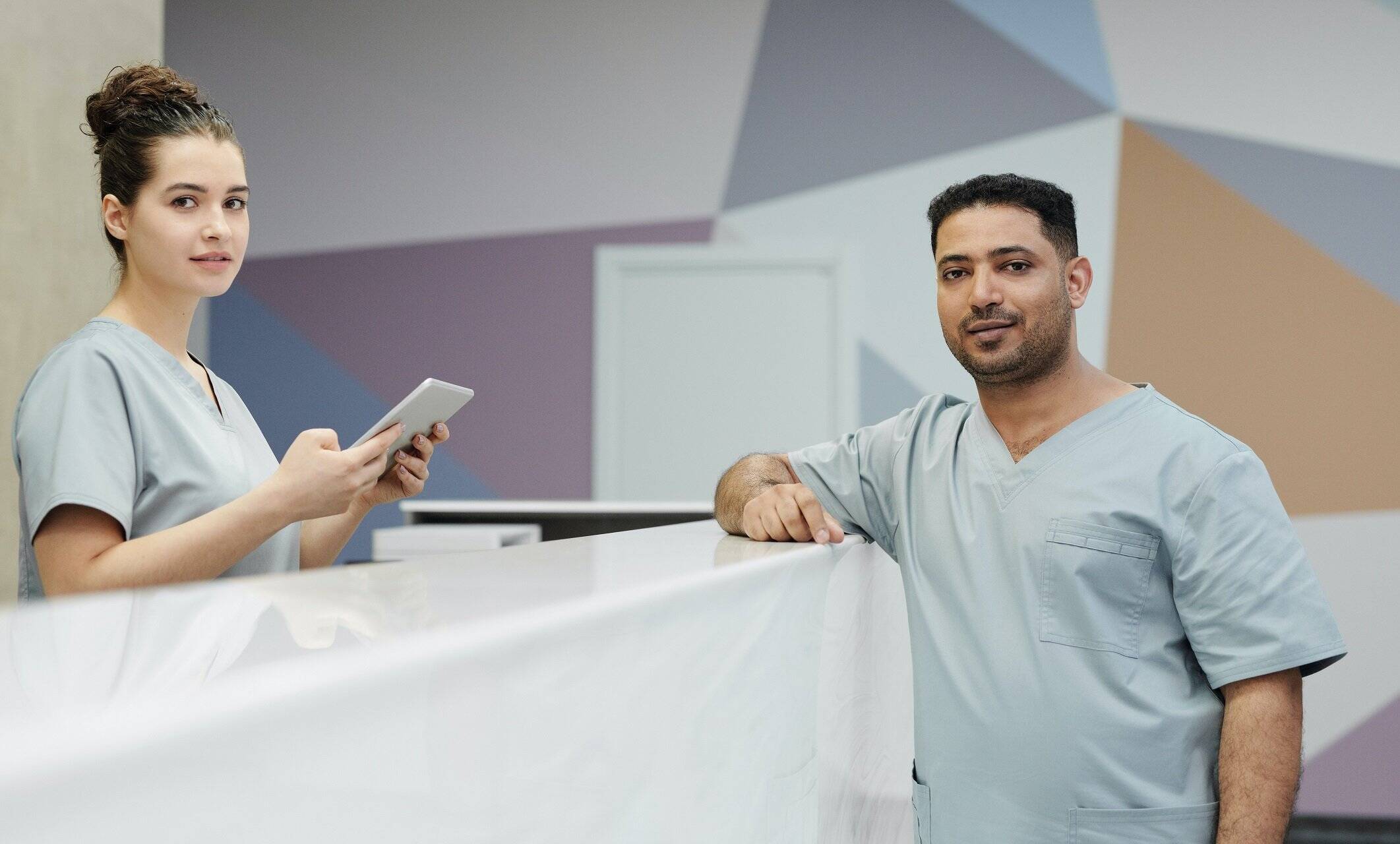 Two people discussing virtual medical receptionist vs in-person medical receptionist