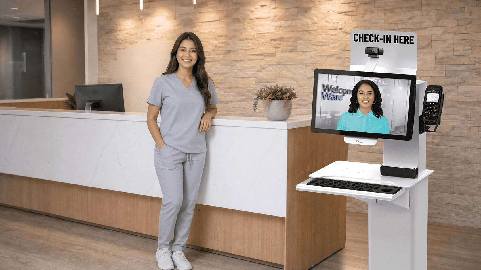 A woman stands before a computer monitor, appearing focused and attentive to the screen's content
