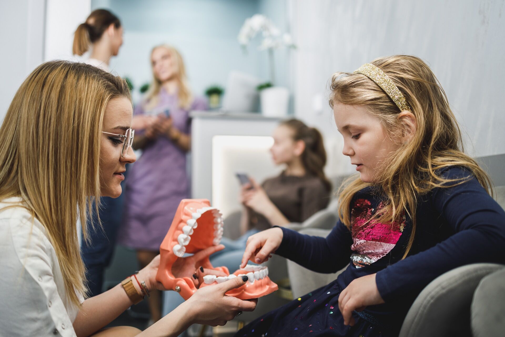 Dental office receptionist assisting the patient