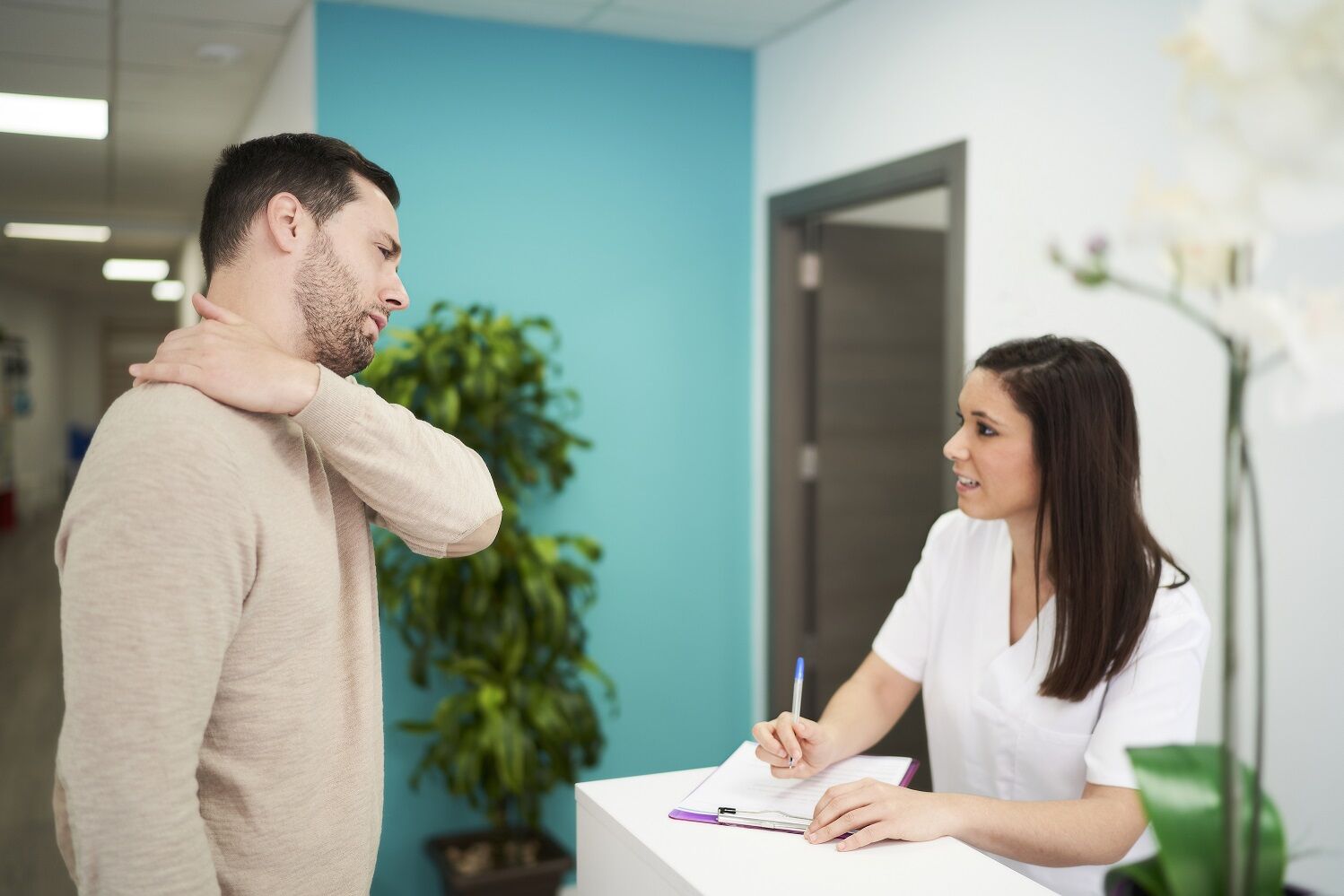 Patient talking to physiotherapy receptionist