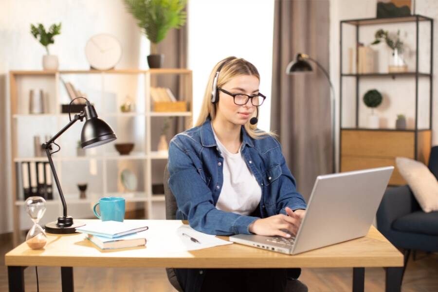 Remote medical assistant managing patient inquiries on a laptop