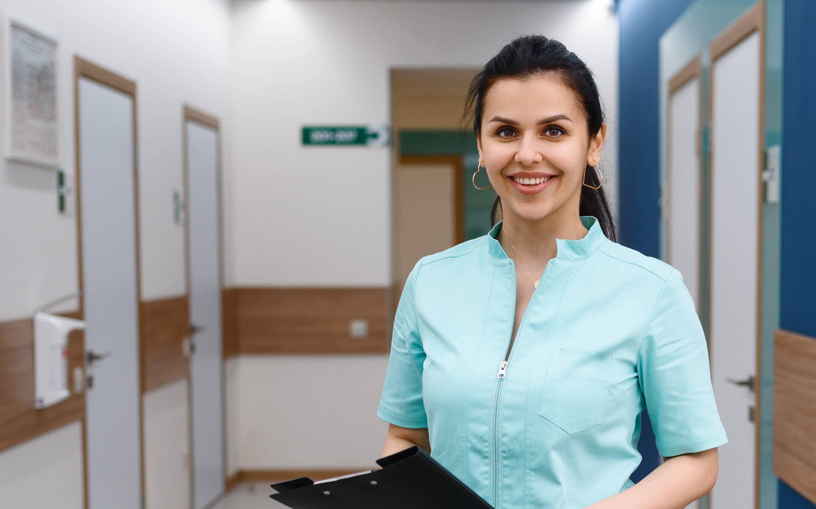 Smiling behavioral health receptionist with clipboard