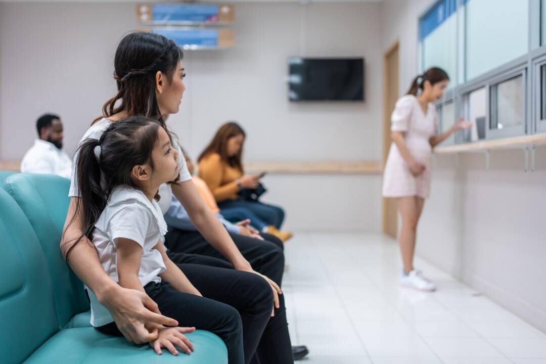 Parent and child waiting in clinic, how to improve patient wait times