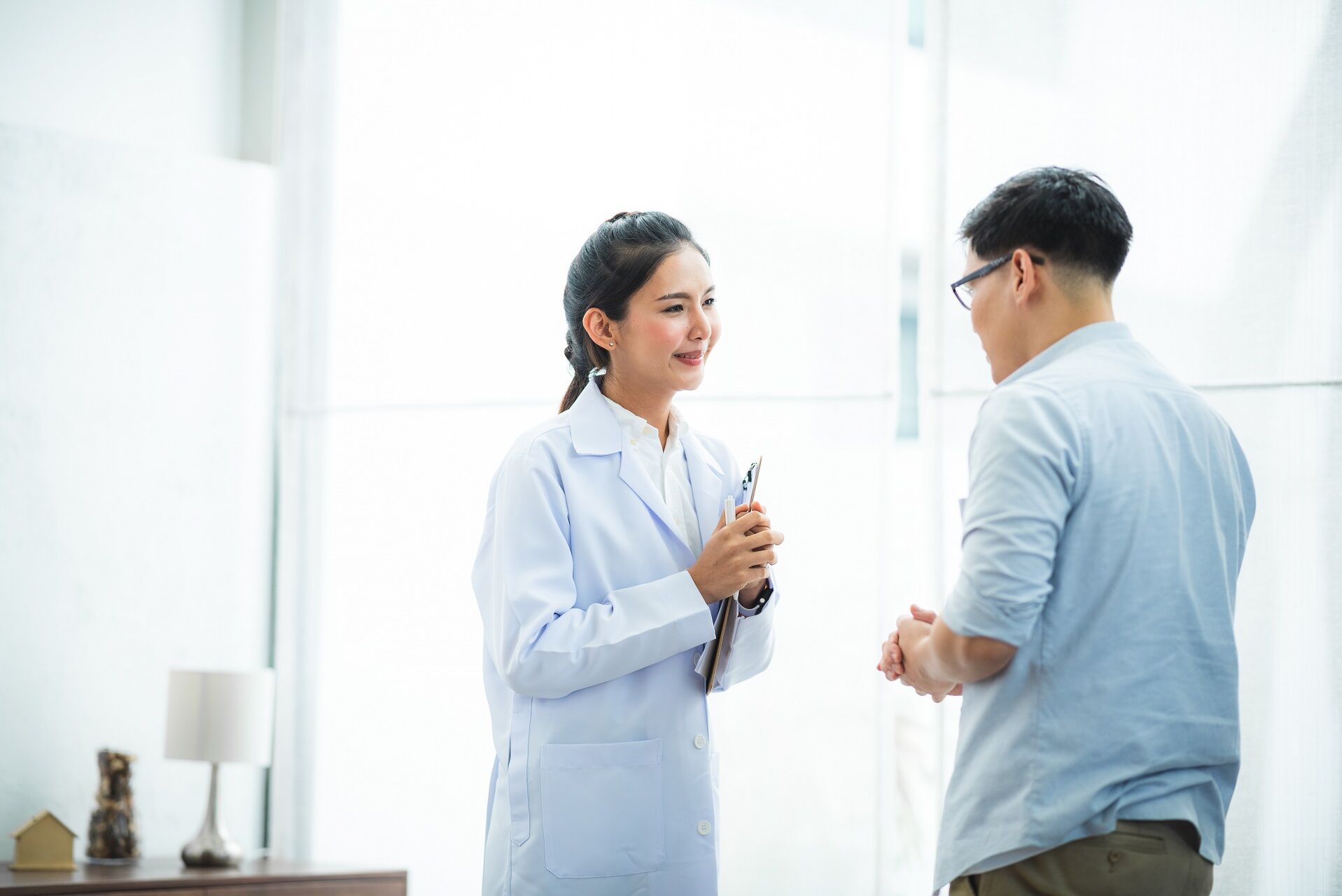 Psychiatrists doctor provide mental health counseling at home. Receptionist accommodating patient at mental health front desk