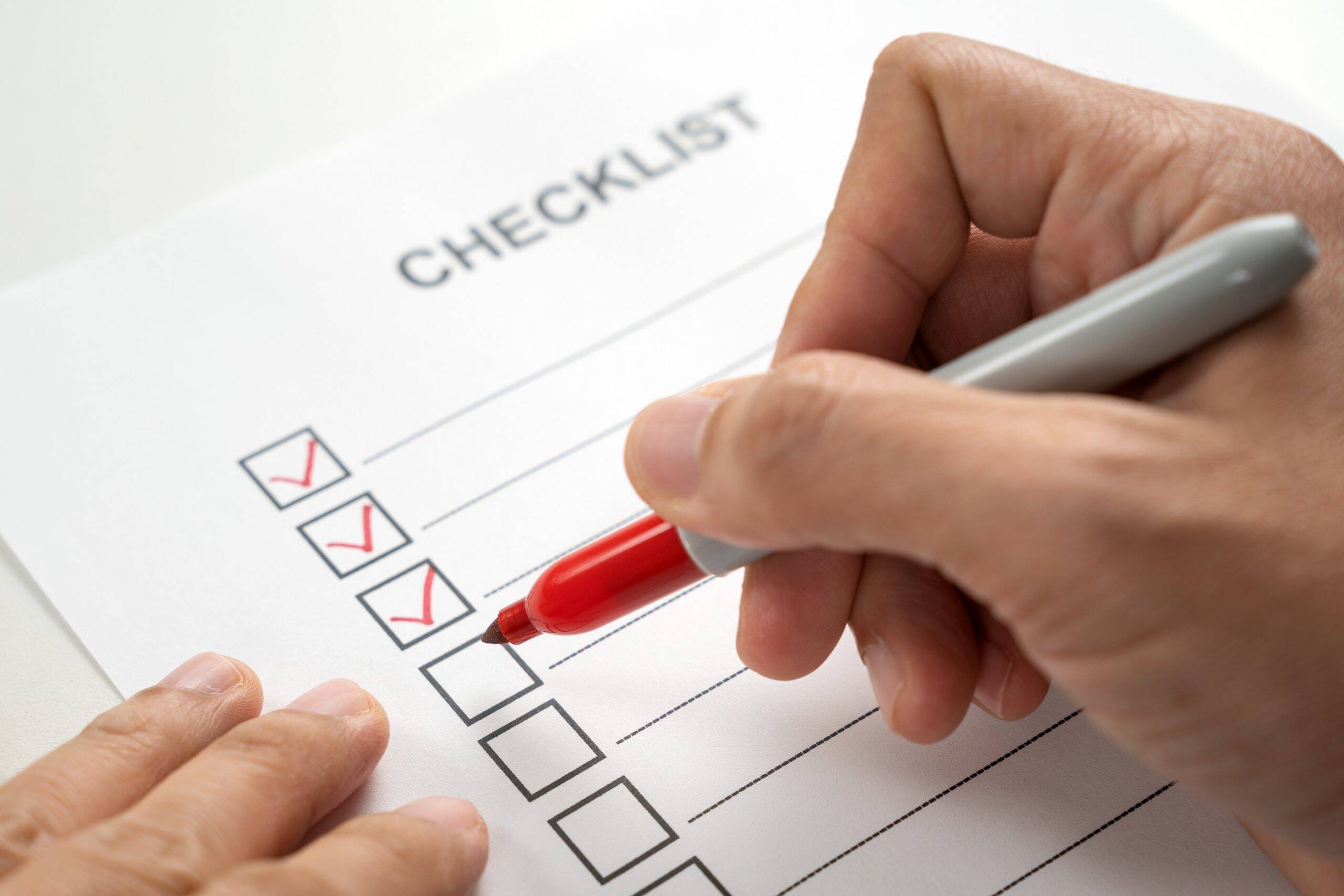 Person writing the visitor management system features